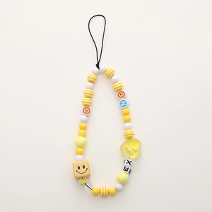 Handmade beaded phone strap with yellow candy beads, smiley face cube and heart charm