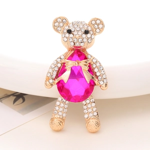 Detailed macro view of a sparkling teddy bear charm with pink teardrop crystal and rhinestones
