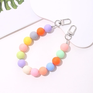 Macro detail of a colorful beaded acrylic phone strap with two silver lobster clasps