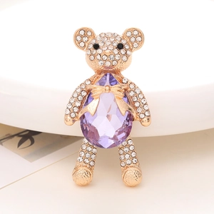 Detail of bear charm featuring a large purple teardrop gem and sparkling crystal rhinestones