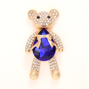 Sparkling crystal bear pendant with deep blue teardrop gemstone and gold finish