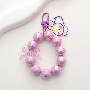 Detail of purple iridescent beaded bear keychain with cute rabbit charm and lobster clasp