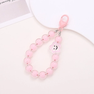 Macro shot of pink double-layer acrylic beads with a star smiley face and heart clasp