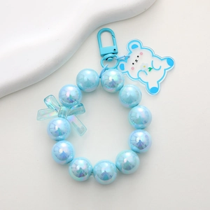 Detailed view of dreamy blue pearlescent beads keychain with cute bear acrylic charm