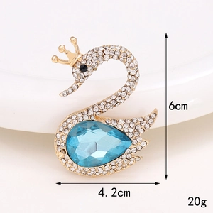 Broche cygne étincelante avec cristal bleu et strass blancs sur base en alliage doré