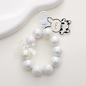 Detailed macro view of mermaid bead keychain with acrylic cartoon rabbit cow charm