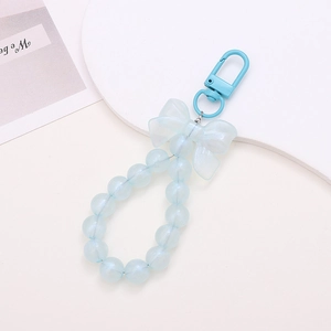 Detail of light blue beaded bow keychain with acrylic pearls and lobster clasp
