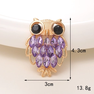 Golden owl brooch with purple marquise gems, dimensions 4.3cm by 3cm, weighing 13.8g