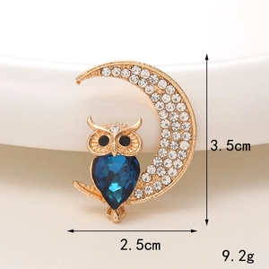 Close-up showing owl brooch dimensions 3.5cm x 2.5cm with blue teardrop gemstone