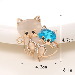 Macro view of twin owl brooch showing 4.7cm by 4.2cm dimensions and opal crystals