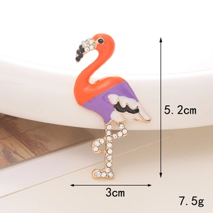 Detailed view of a flamingo brooch with colorful crystals and oil drip finish