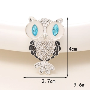 Detail view of owl accessory showing 4cm x 2.7cm size and blue rhinestone eyes