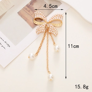 Spilla elegante a fiocco con perle, catene placcate in oro e pendenti a nappa