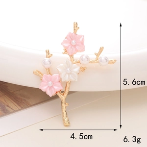 Detailed view of plum blossom branch brooch with pearls and dimensions 5.6cm x 4.5cm