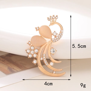 Golden peacock brooch with champagne cat-eye stones and rhinestones showing size measurements
