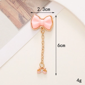 Ciondolo a fiocco in resina rosa con catena dorata e strass, largo 2,3cm e lungo 6cm