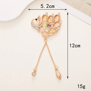 Peacock tassel brooch with pink cat eye stone and crystal details, 12cm length measurements