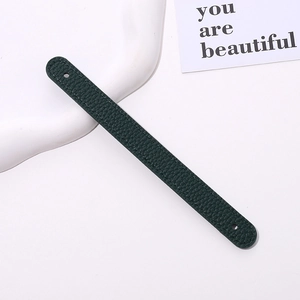 Detail of dark green lychee textured leather wrist strap with fine edge stitching
