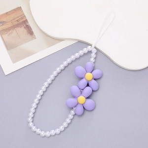 Detail of white faux pearl phone wrist strap with two purple sunflowers on white display