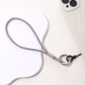 Close-up of luxury light purple rhinestone phone charm strap with silver metal ring buckle