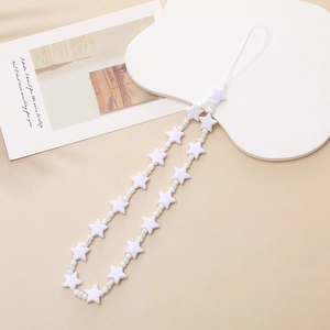 Macro detail of white star-shaped beads and round pearls on a minimalist phone strap