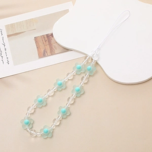 Detail of frosted light green flower beads and mint round beads on phone wrist strap