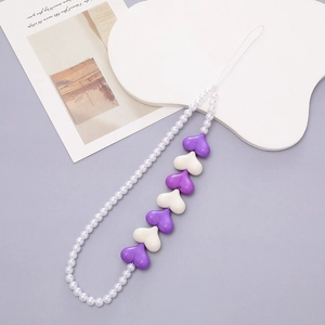 Detail of beaded phone wrist strap with purple acrylic hearts and white pearls