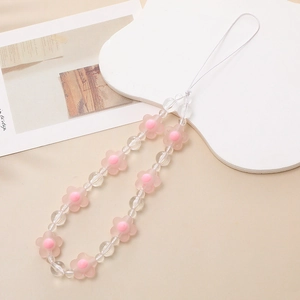 Detailed macro view of pink matte flower beads and clear crystal beads on phone strap