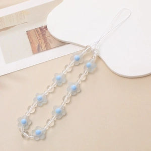 Detail of light blue frosted flower and transparent beads on a stylish wrist strap