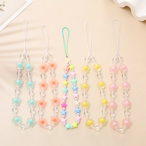 Close-up of matte candy-colored flower and star beaded phone charms in five colors