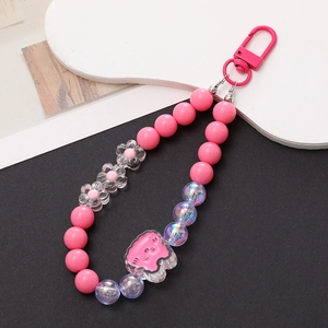 Close-up of pink acrylic bunny keychain with assorted pastel beads and metal lobster clasp