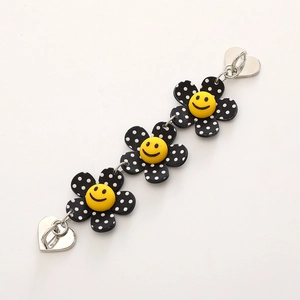 Colorful acrylic phone chain with three polka dot flowers and yellow smiley faces