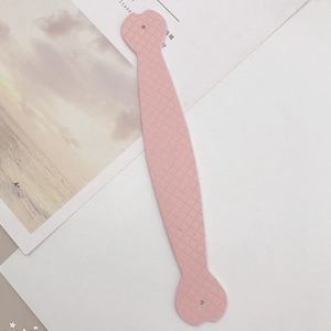 Detailed view of pink silicone handle with diamond grid texture and round mounting holes