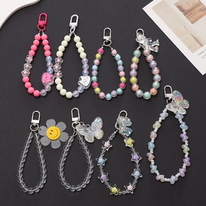 Close-up of various acrylic beaded phone straps with cute animal and heart pendants