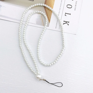 Detail of elegant long white pearl phone strap with large bead on minimalist background