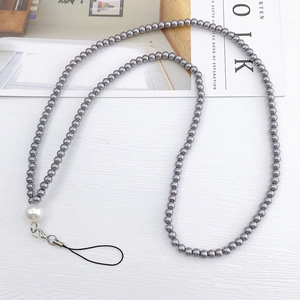 Detail of beaded mobile phone strap with metallic grey beads and a white pearl accent