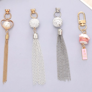 Detail view of Maneki Neko ceramic charm and elegant tassel pendants for phone case DIY