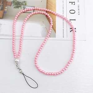 Close-up of pink faux pearl phone lanyard with large white pearl and metal lobster clasp