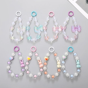 Detailed view of colorful frosted bead keychains with butterfly bows and cute rabbit charms