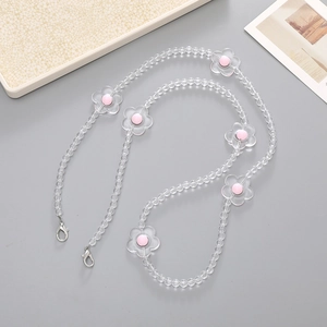 Detail of beaded phone strap featuring clear crystal beads and pink flower charms