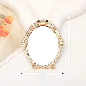 Detail showing the rhinestone penguin vanity mirror with gold frame and crystal accents