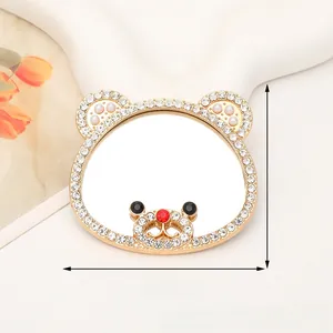 Detail of bear shaped mirror accessory with gold plating, rhinestones and size labels