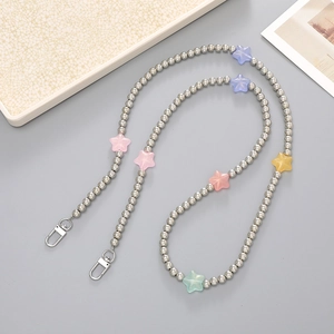 Detailed macro view of beaded phone strap with silver beads and colorful star charms