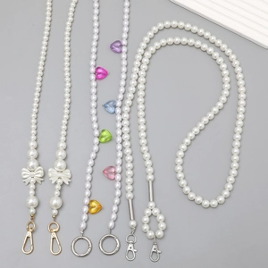 Elegant pearl lanyard with colorful heart pendants and bow accents for phone or bag strap
