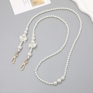 Elegant white pearl crossbody chain with decorative bows and gold metal lobster clasps