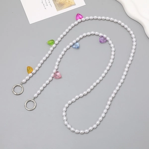 Crossbody pearl phone strap with five colorful transparent heart-shaped pendants and silver clasps
