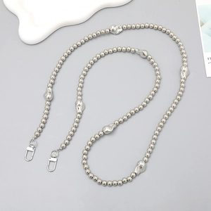 Silver beaded crossbody strap with unique irregular metallic charms and lobster clasps