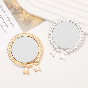 Elegante runde Spiegel im Vintage-Stil mit Perlenrand und dekorativen Schleifen in Gold und Silber