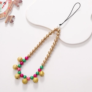 Detail view of Christmas phone charm with colorful beads, golden bell, and pearl accent