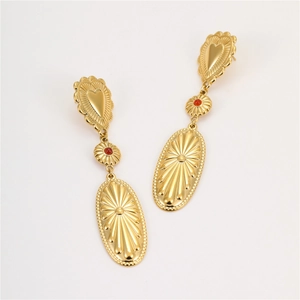 Detail of vintage bohemian gold earrings with heart studs and red bead charms